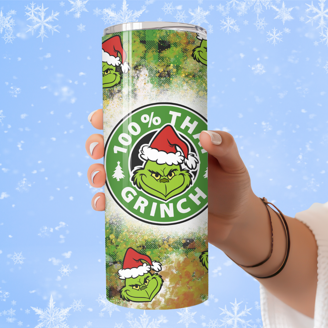Tumbler with Grinch design held by a hand against a snowy background. 100% That Grinch Christmas Tumbler – Funny Holiday Coffee Cup