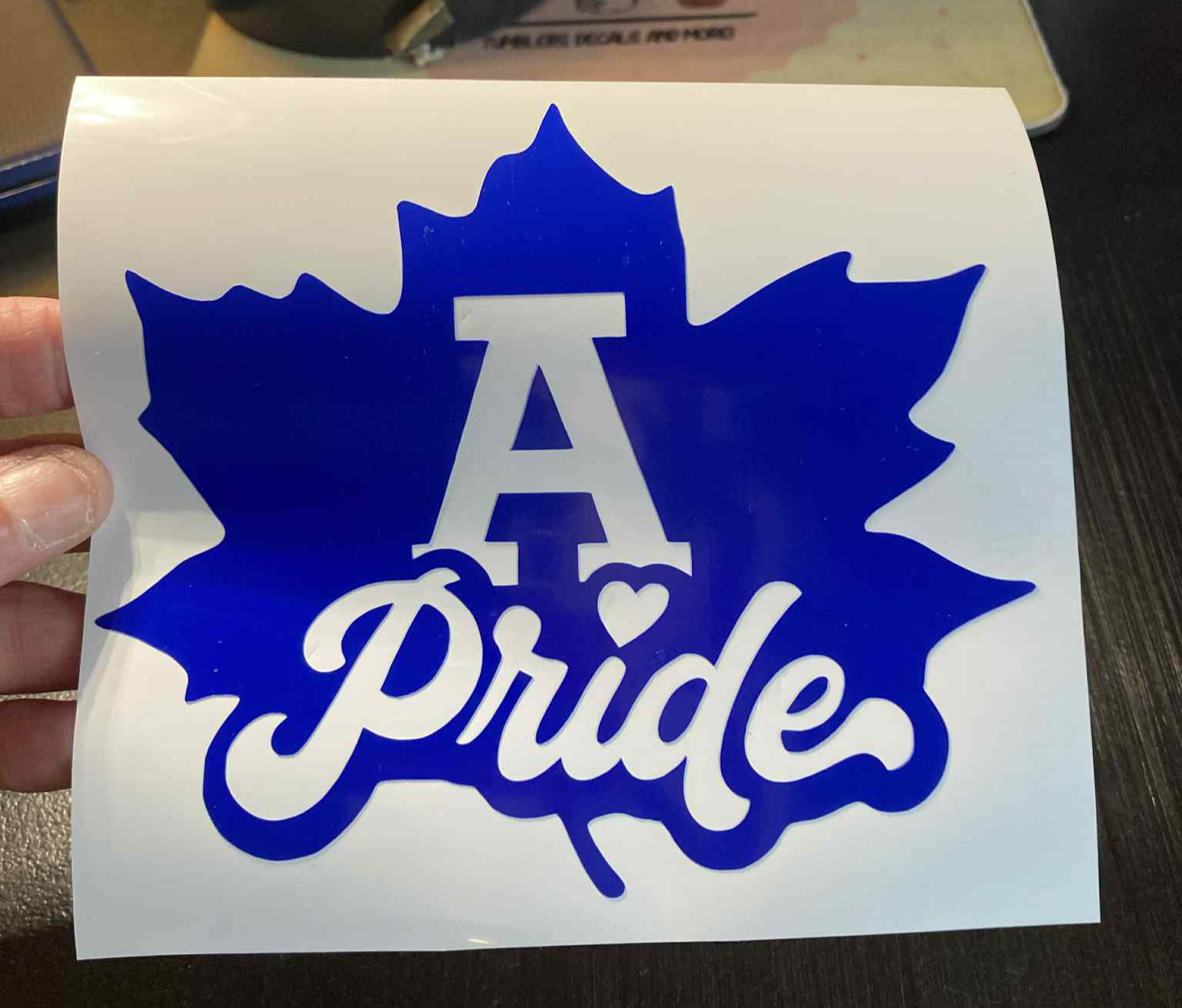 Blue Adrian Maples vinyl decal featuring a bold maple leaf and “A Pride” text – perfect for cars, laptops, water bottles, and school spirit