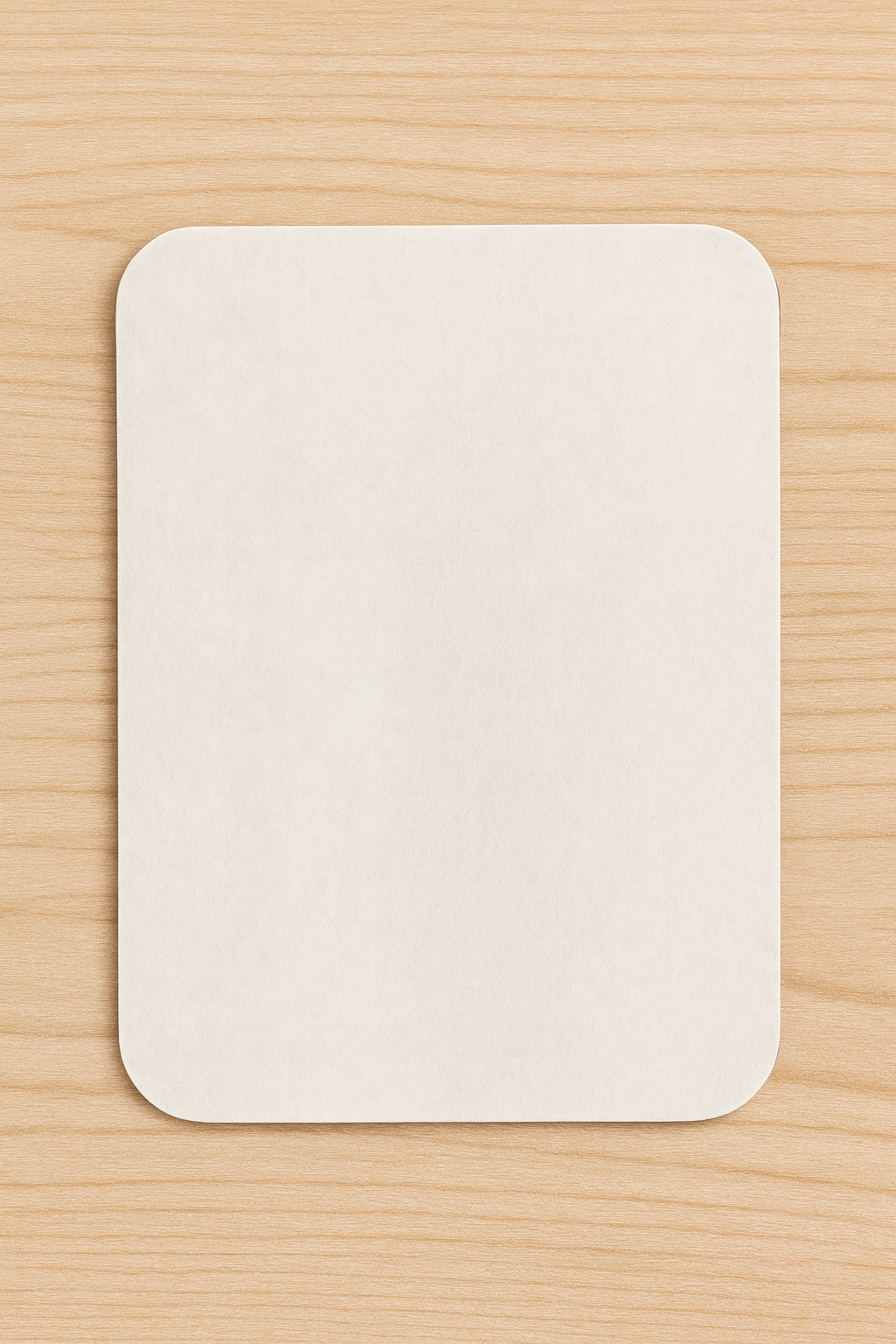 White sublimation magnet blank on a wooden surface