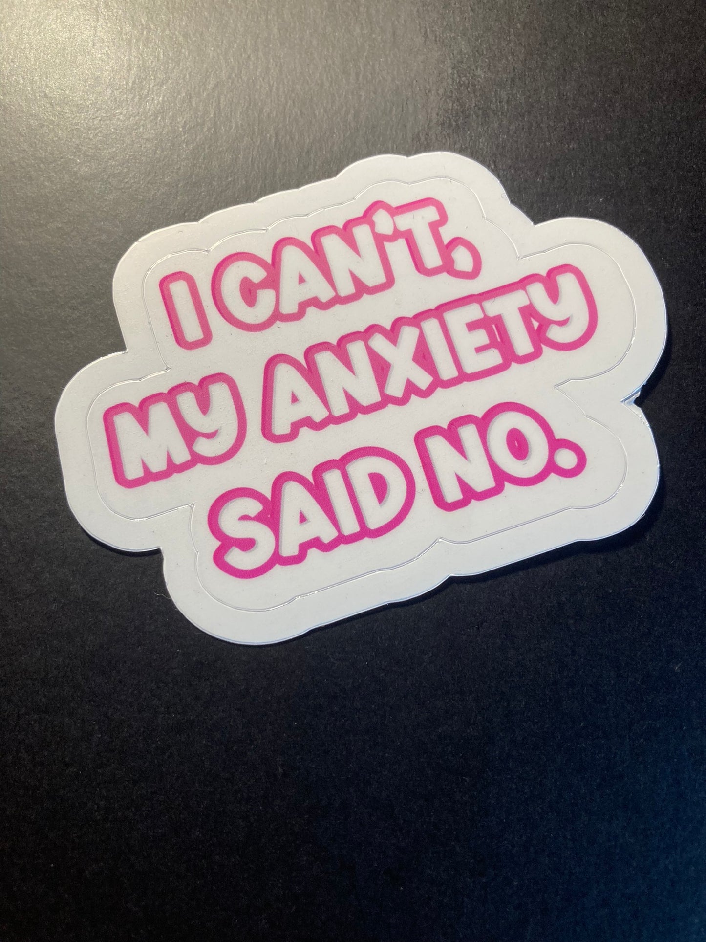 Sticker with text 'I can't, my anxiety said no.' on a dark background