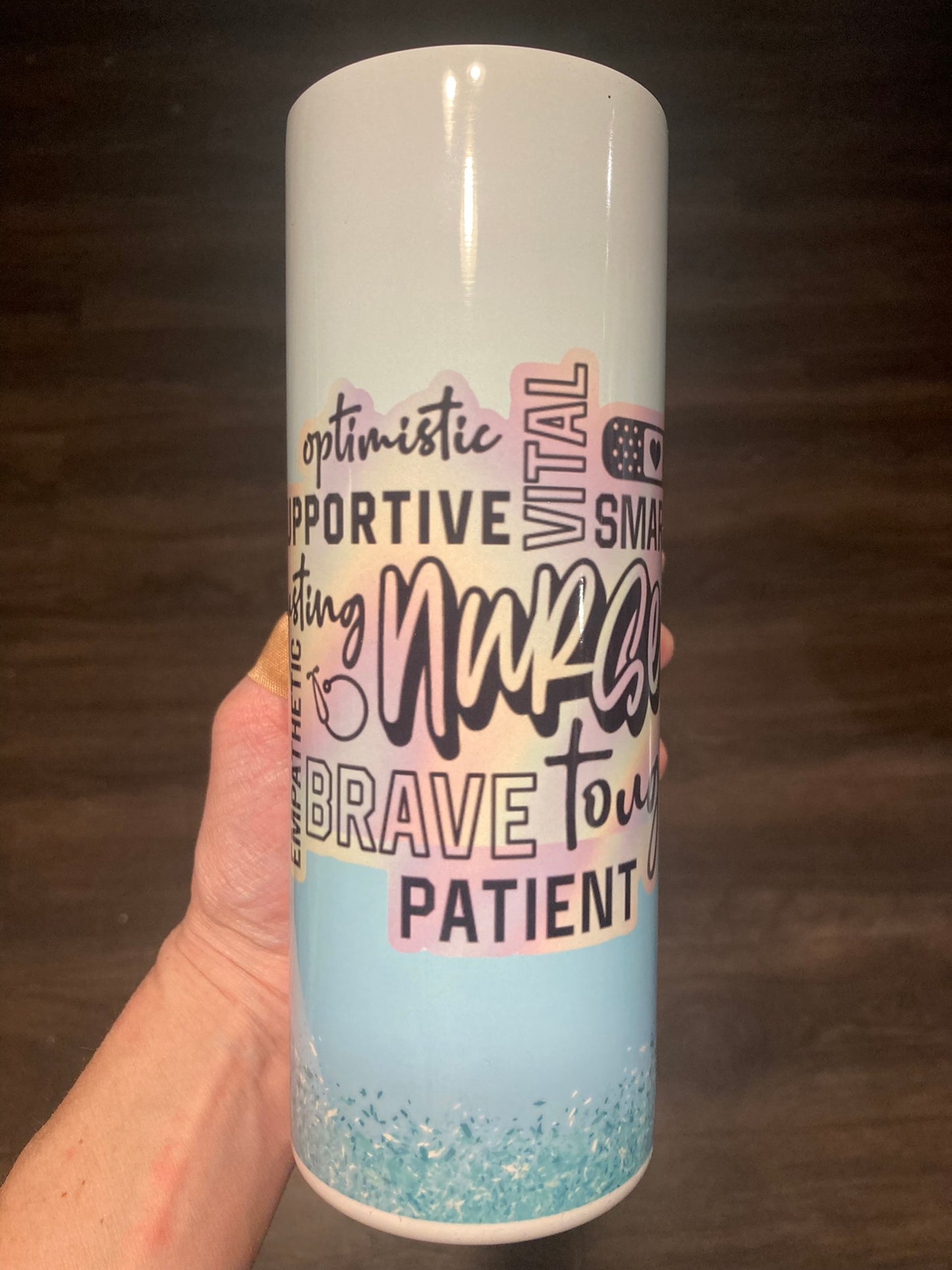 Tumbler with motivational text held by a hand on a dark background. Nurse Affirmation Tumbler. Nurse affirmation tumbler designed for healthcare heroes. Encouraging, practical, and ready to ship.