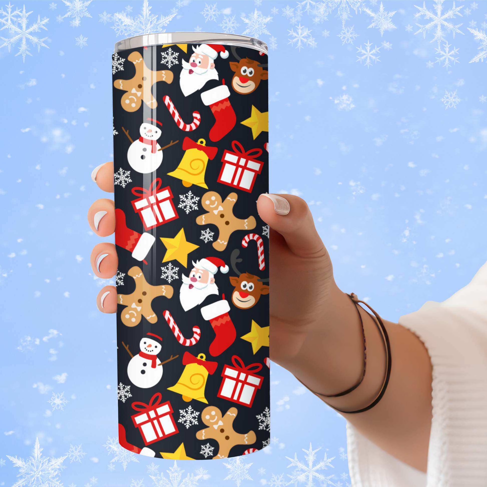 Tumbler with Christmas pattern held by a hand against a snowy background