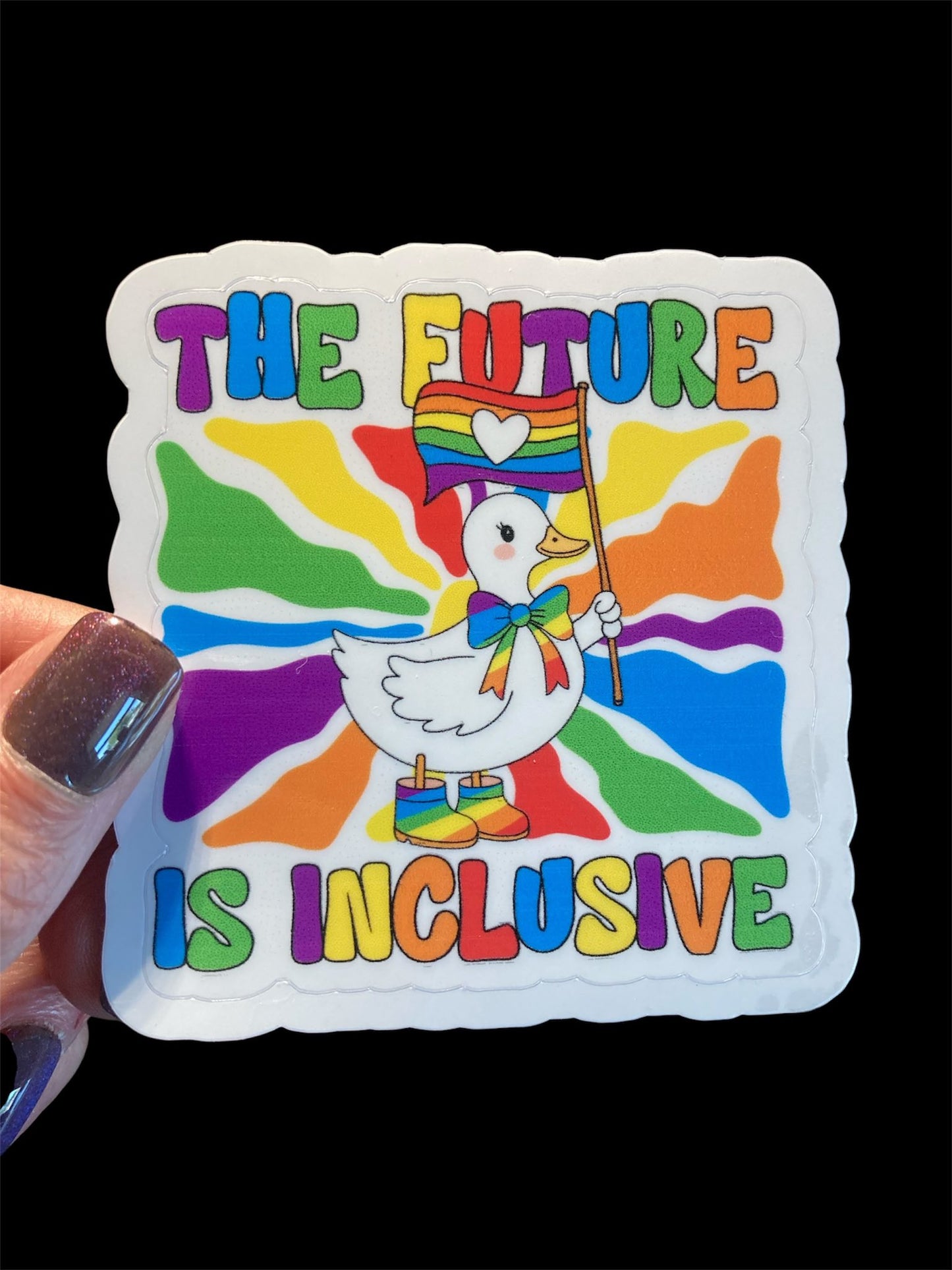 Sticker with a colorful design featuring a duck holding a rainbow flag and text 'The Future is Inclusive' on a black background.