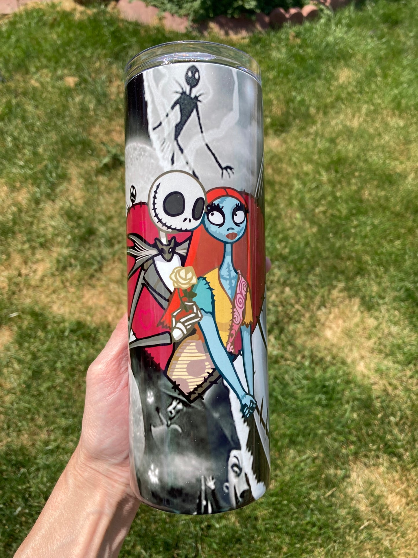 Title:
Nightmare Before Christmas Jack & Sally 20oz Tumbler. 20oz skinny tumbler with Jack and Sally artwork from The Nightmare Before Christmas in a grayscale-to-color design.