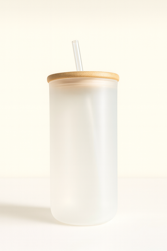 White tumbler with a wooden lid and straw on a white background