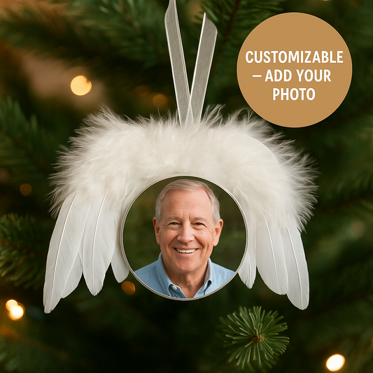 Decorative angel wing ornament with customizable photo feature on a Christmas tree.
