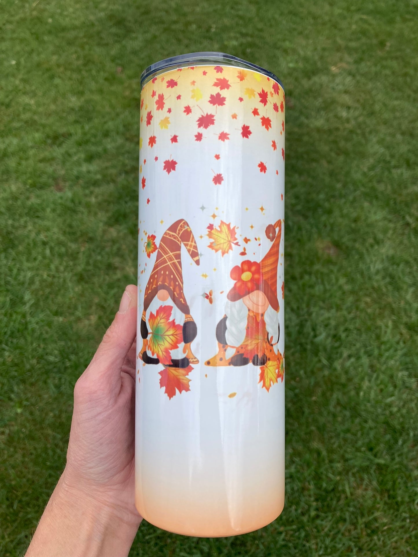 20oz tumbler featuring two fall gnomes surrounded by autumn leaves.