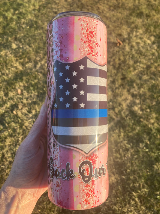 20oz skinny tumbler featuring thin blue line American flag with pink splatter background and “Back the Blue” design