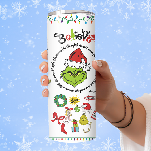 Tumbler with Christmas-themed designs and text held by a hand against a snowy background
