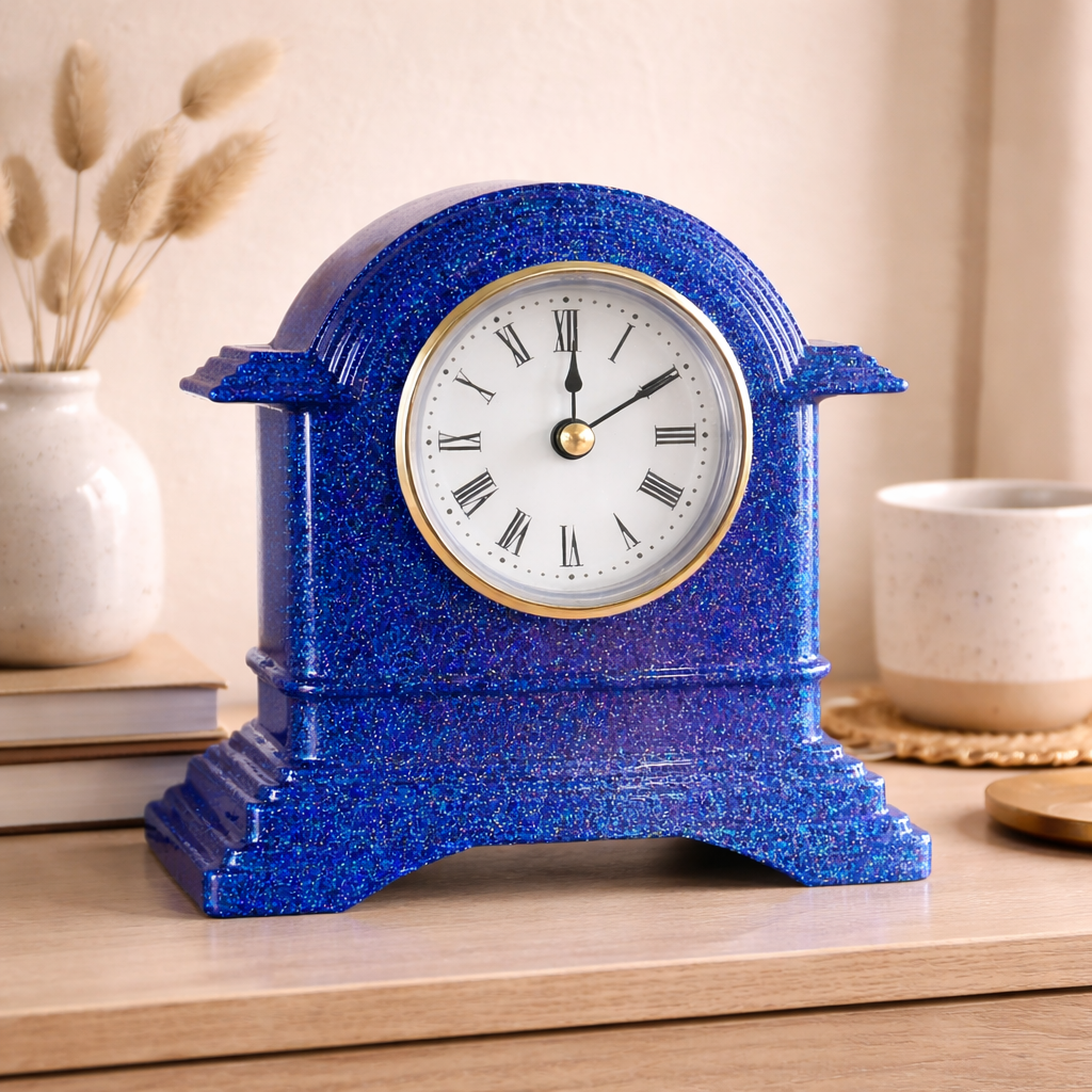 Blue glittery clock on a wooden surface with decorative items in the background