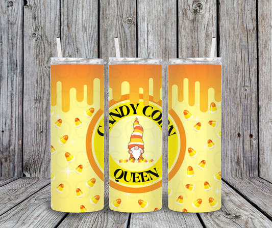 Three tumbler cups with candy corn design and 'Candy Corn Queen' text against a wooden background.