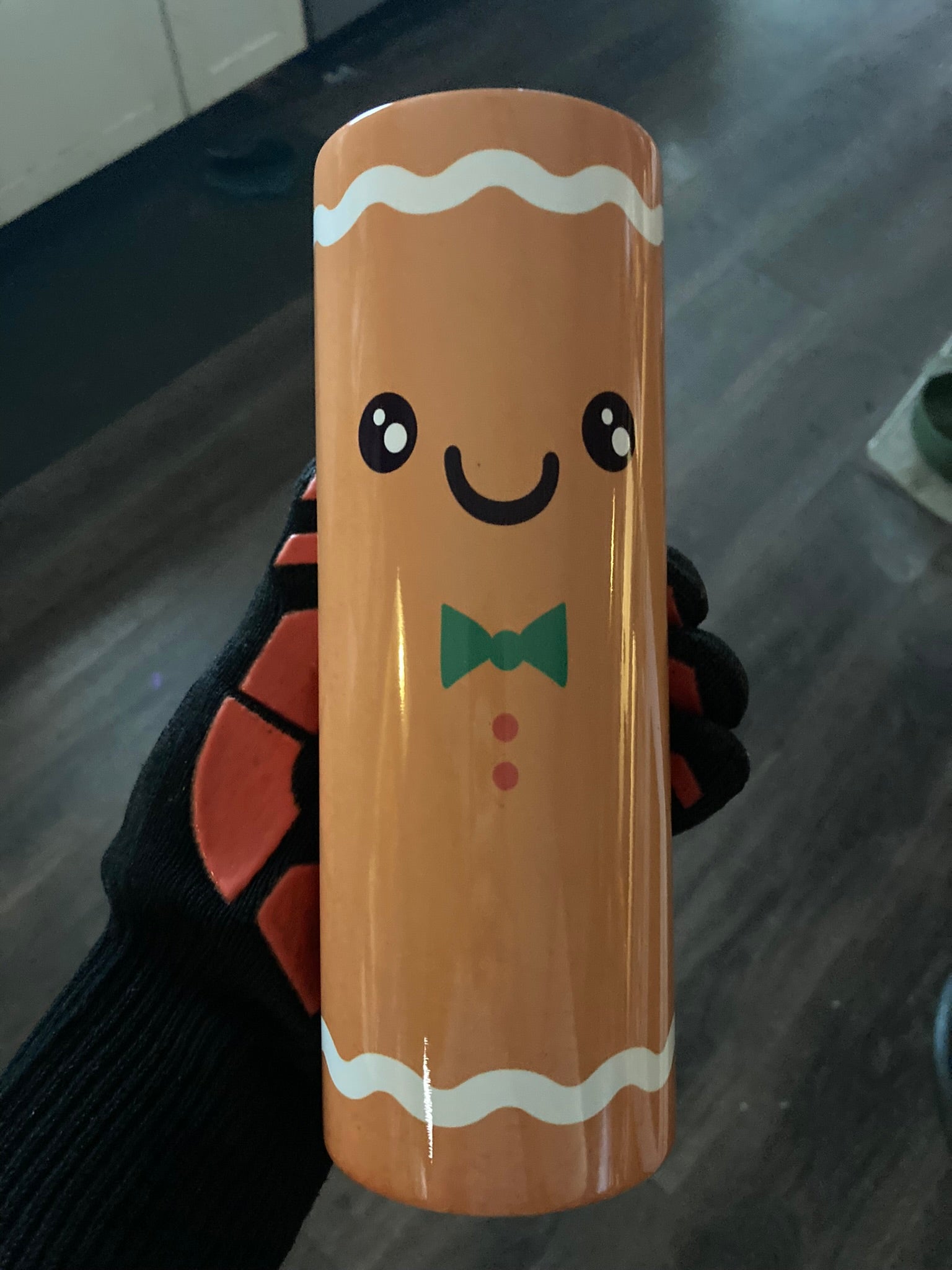 Cute gingerbread man tumbler with smiling cookie character and bow tie design