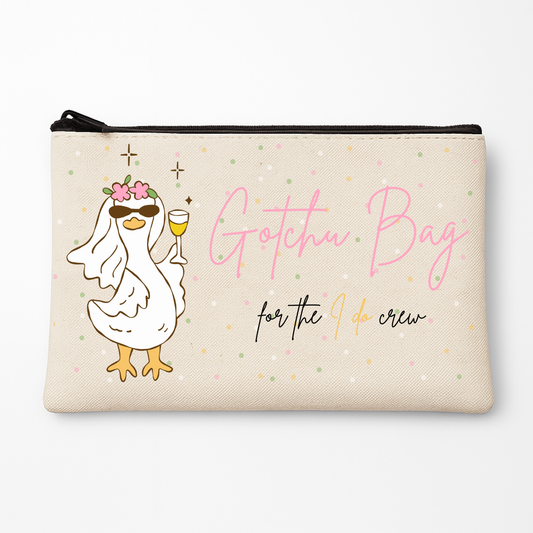 Pouch with a cartoon duck holding a glass of wine and text 'Gotchu Bag for the I do crew' on a white background