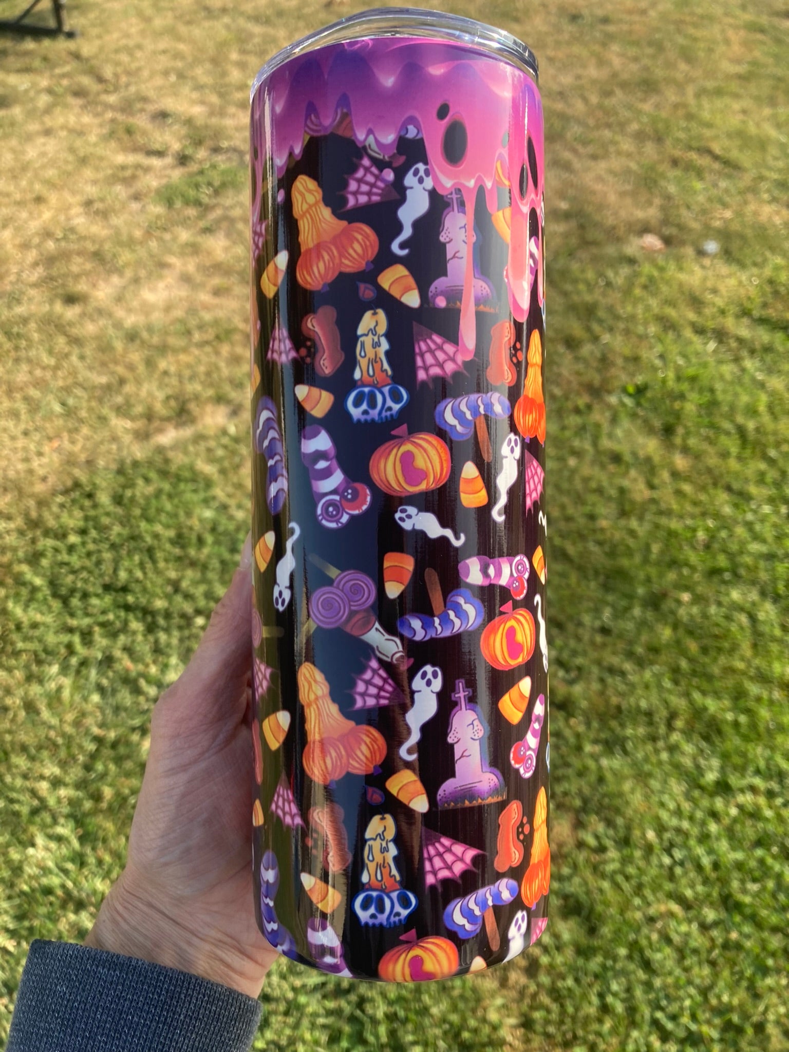 Halloween themed adult novelty tumbler featuring colorful spooky candy, ghosts, pumpkins and playful penis shapes in a bold dark pattern