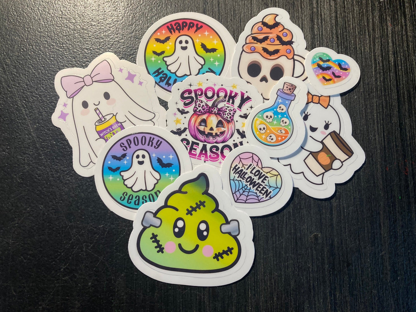 Set of Halloween-themed stickers on a dark surface