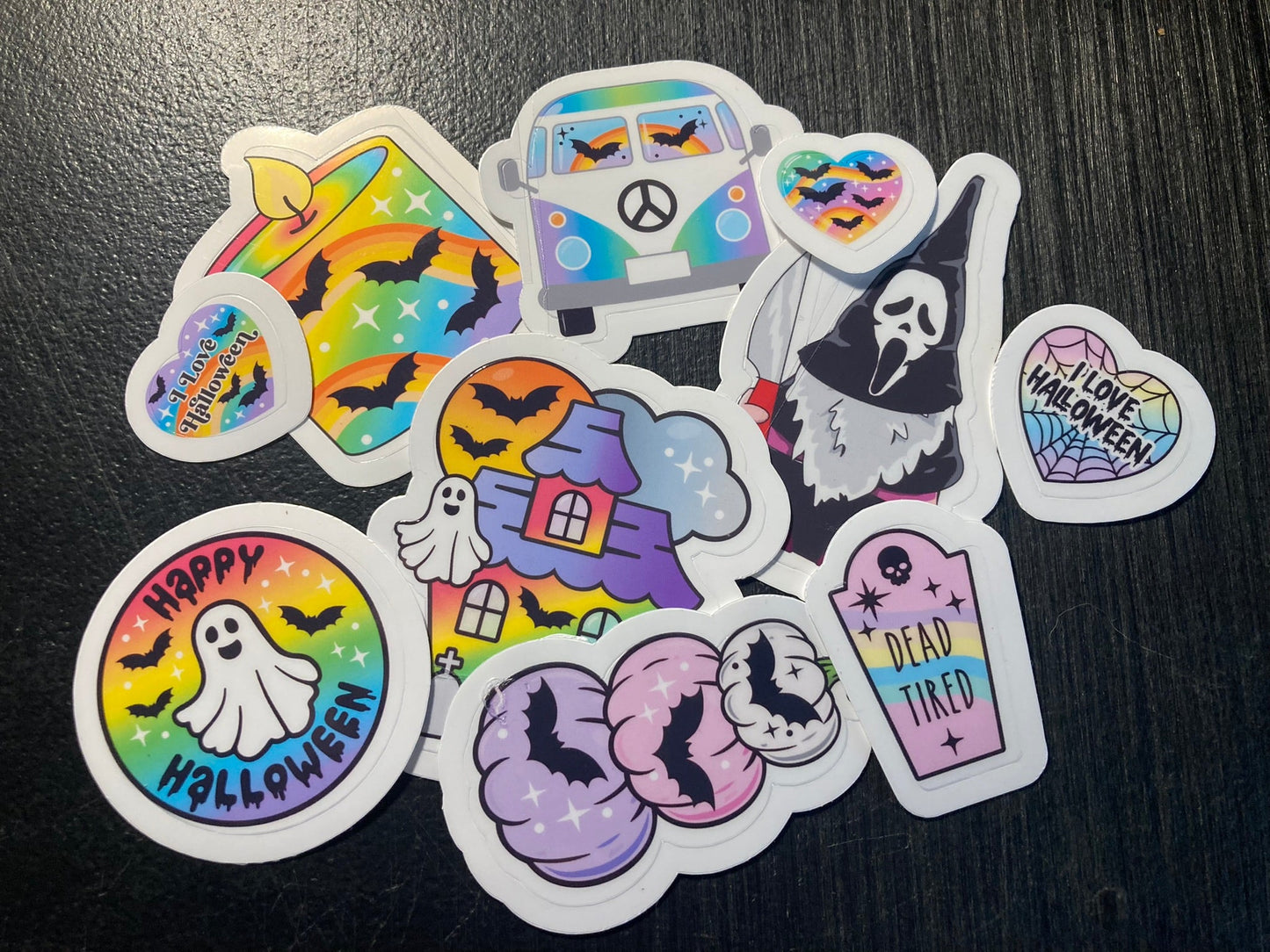 Set of colorful Halloween-themed stickers on a dark surface