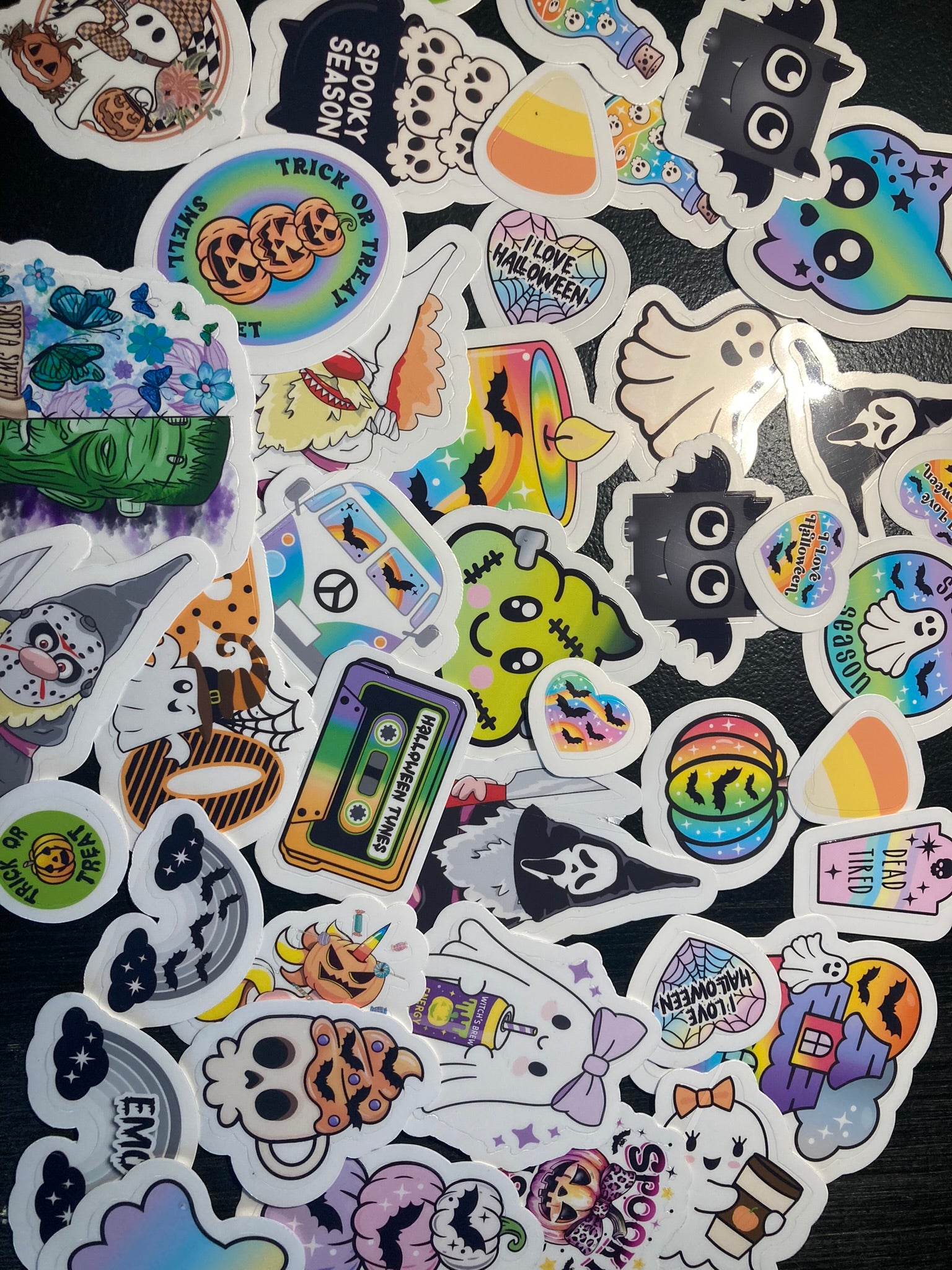 Collection of colorful stickers with various designs on a black background