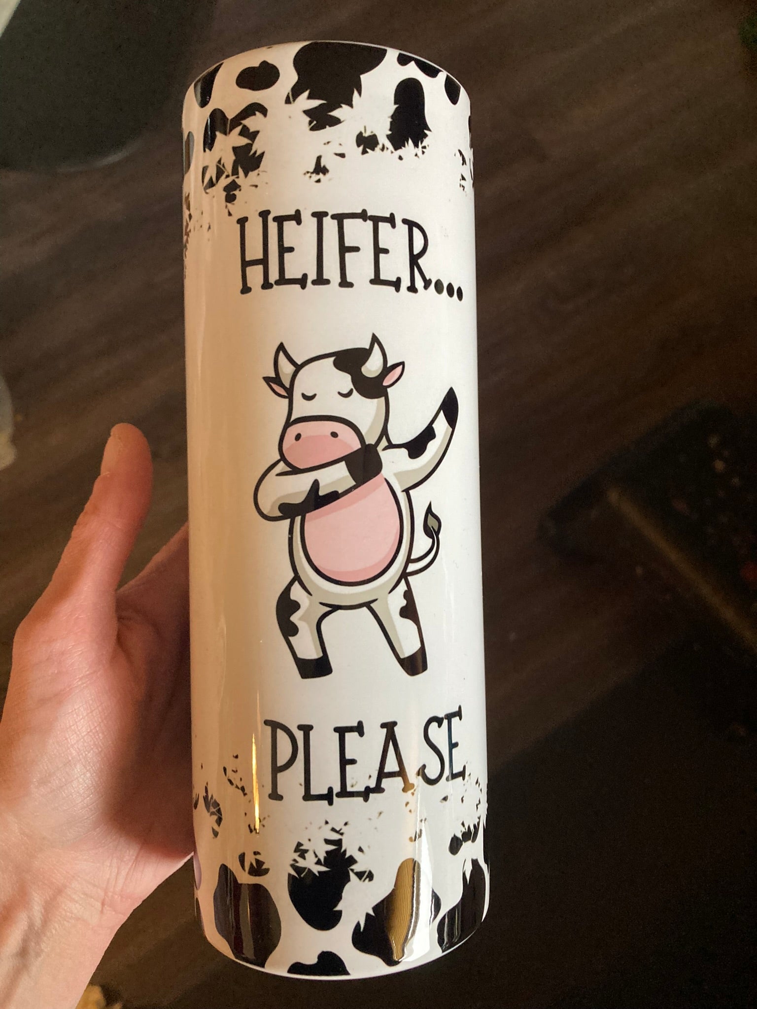 Heifer Please Funny Cow 20oz Skinny Tumbler. Black/white cow print, 20oz tumbler featuring a dancing cartoon cow and humorous “Heifer Please” text.