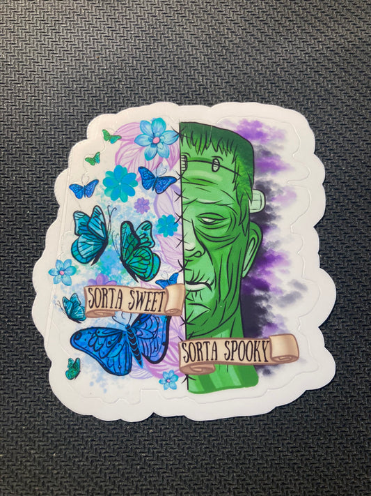 Sticker split between colorful butterflies/flowers on one side and Frankenstein monster face on the other, with text “Sorta Sweet Sorta Spooky.”