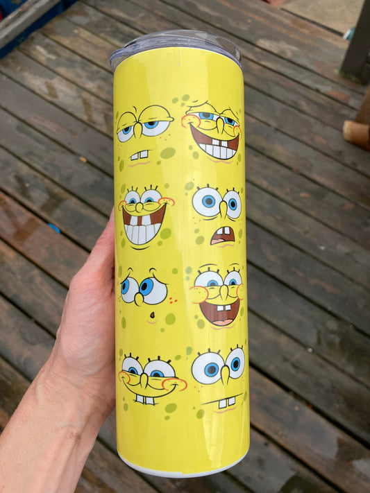 Yellow tumbler covered in multiple SpongeBob facial expressions in a fun cartoon pattern design