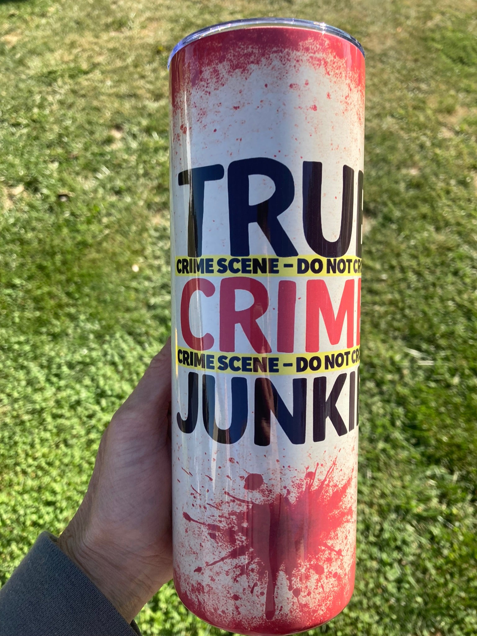 True crime junkie tumbler with crime scene tape design and red splatter horror aesthetic