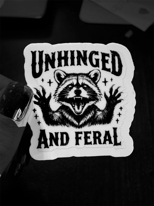 Unhinged and Feral (raccoon) waterproof die cut sticker