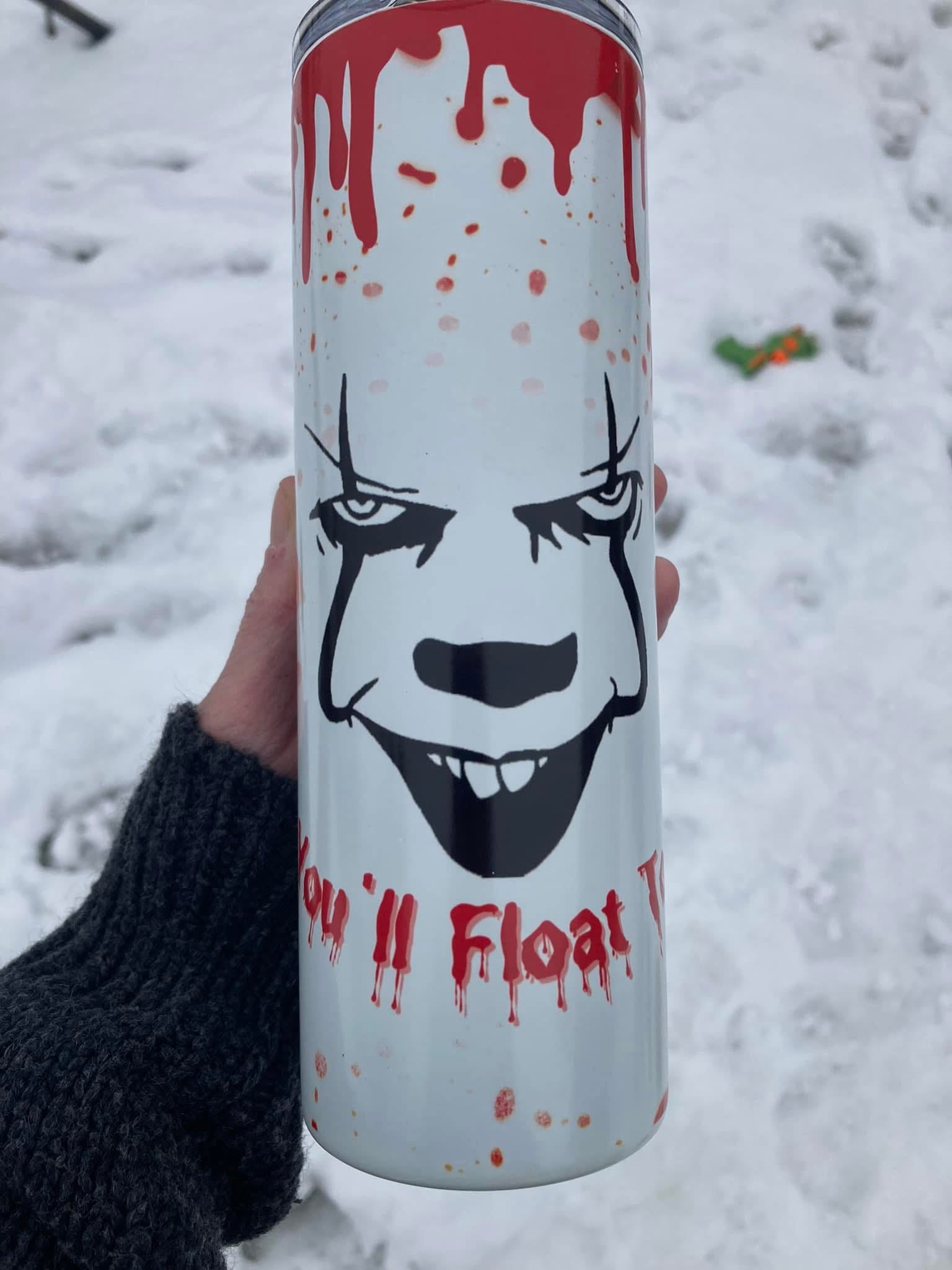 White horror tumbler with creepy clown face and “We All Float” blood drip design