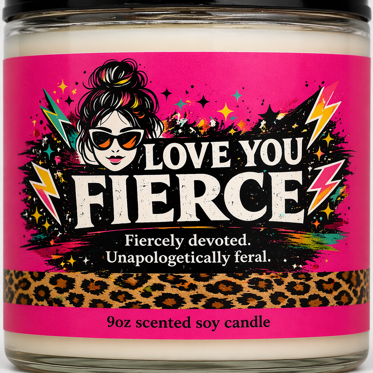Scented candle jar with a colorful label featuring text and graphics on a pink background.